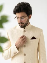 Men's Royal Ivory Jacquard Prince Coat with premium silk kurta pajama, featuring a textured pattern, mandarin collar, decorative buttons, and maroon pocket square, perfect for weddings and formal occasions.
