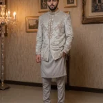 Ivory embroidered Prince Coat for men with elegant detailing, paired with white shalwar kameez for groom and wedding wear.