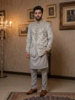 Ivory embroidered Prince Coat for men with elegant detailing, paired with white shalwar kameez for groom and wedding wear.