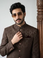 Model wearing a royal chocolate brown jacquard prince coat with an elegant woven pattern, paired with a matching silk kurta suit, perfect for weddings and formal occasions.