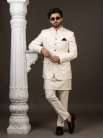 Men's premium ivory white Jacquard Prince Coat with golden buttons, Mandarin collar, and maroon pocket square, paired with a luxurious silk kurta trouser suit, perfect for weddings and formal occasions.