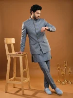 Men's steel grey jacquard prince coat with elegant metallic buttons and mandarin collar, paired with a matching silk kurta and trousers for weddings and formal occasions.