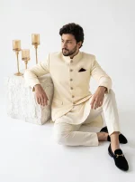 Men's Royal Ivory Jacquard Prince Coat with premium silk kurta pajama, featuring a textured pattern, mandarin collar, decorative buttons, and maroon pocket square, perfect for weddings and formal occasions.