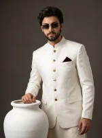 Men's premium ivory white Jacquard Prince Coat with golden buttons, Mandarin collar, and maroon pocket square, paired with a luxurious silk kurta trouser suit, perfect for weddings and formal occasions.